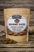 A stand-up kraft paper pouch of Beltin Pet Treats Gourmet Slices Chicken & Salmon, with a clear window showing round dog treats inside, photographed on a rustic wooden surface with a few treats placed in front.